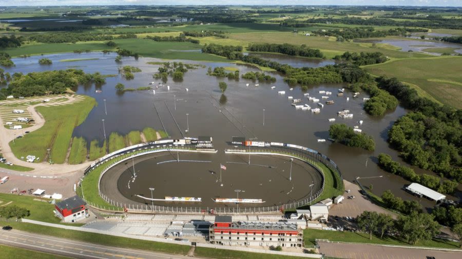 Floodwaters inundate the Midwest as scorching temperatures continue across the country