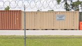 A Navy base put up a wall to ward off stray bullets. Locals say that doesn't solve gun violence.