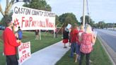 Gaston County teachers gather outside of South Point High School to protest against payroll issues