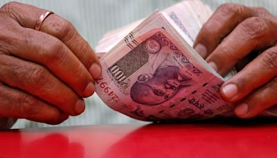 Rupee ticks up on foreign banks' dollar sales; forward premiums slip