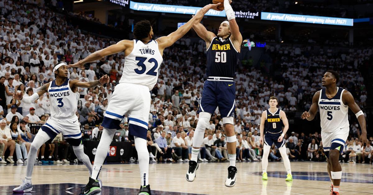 Aaron Gordon of the Denver Nuggets takes a shot over Karl-Anthony Towns of the Minnesota Timberwolves during the fourth quarter in Game 4 of...