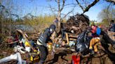 Volunteers clean up small Willamette River island before spring runoff washes debris downstream