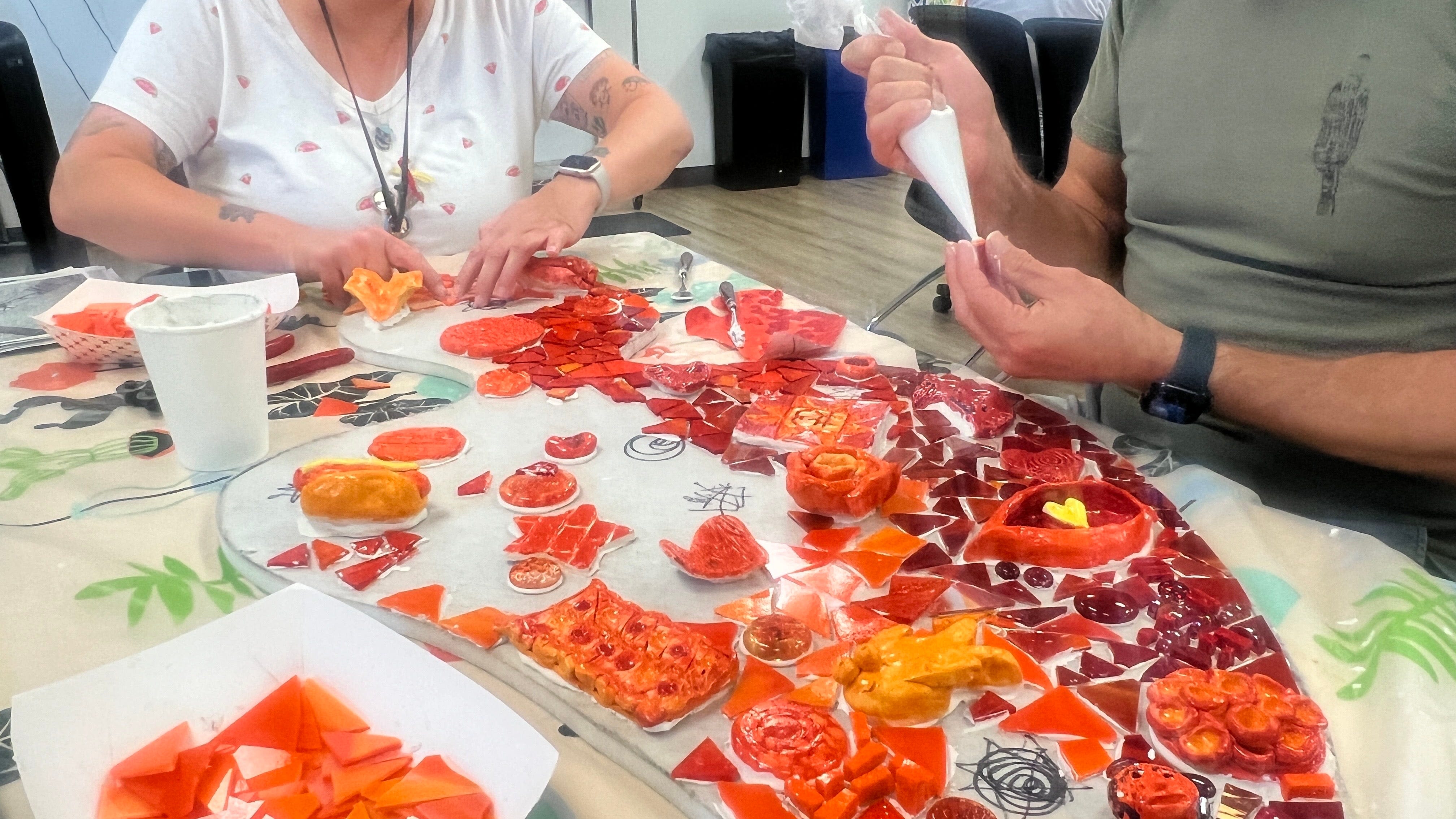 Local volunteers transform Damien Center's new HQ with mosaic art