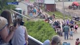 Monster truck clips power line, toppling live wires and utility poles onto spectators