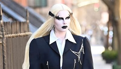 Julia Fox rocks death metal make-up and wig with schoolgirl skirt during NYC stroll with a Saint Bernard