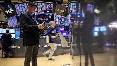 Stocks near flat, dollar dips as focus shifts to US inflation data