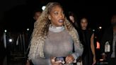 Serena Williams flashes her bra as she gives Edward Enninful a hug