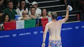 Pool worker strips to his briefs to retrieve a lost swim cap, drawing whistles from fans