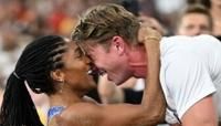 Tara Davis-Woodhall embraces Hunter after she won the Olympics women's long jump title