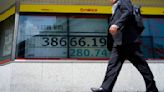 Stock market today: Asian shares edge lower after Wall Street sets more records