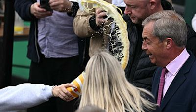 Nigel Farage has pint of milkshake thrown in his face, in pictures