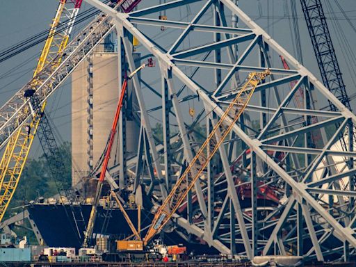 Video shows Baltimore bridge explosion to break up steel span atop cargo ship