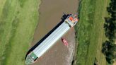 Massive 80-metre long cargo ship gets stuck in Cambridgeshire river