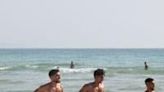 People spend the day on the beach in the port city of Tyre in southern Lebanon despite fears of war with Israel amid near-daily clashes between Hezbollah and Israeli forces