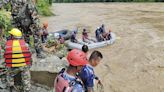 Rescuers recover first body from 2 buses that were hit by landslide and fell into a river in Nepal