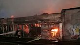 Huge Oakland lumber yard blaze smolders as firefighters probe cause