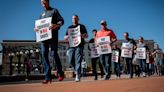 Men try taking a walk in women's shoes in Sexual Assault Awareness Month event