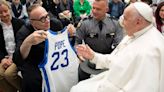 Father Jim gifts Pope Francis a Mark Pope jersey