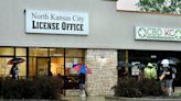 People wait outside the North Kansas City License Office in May 2020.