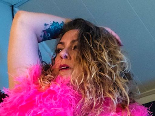 American Pickers' Danielle Colby covers naked body in a neon feather boa