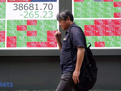 Japan's Nikkei slides, banks rally on reports BOJ mulling rate hike - The Economic Times