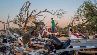 The Crowder family surveys their home destroyed by a tornado on May 7, 2024, in Barnsdall, Oklahoma.