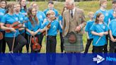 King battles midges on visit to Highland peat bog declared world heritage site