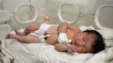 Newborn with umbilical cord intact is rescued from Syria rubble but her mother dies, a relative says