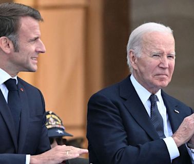 Shocking moment doddering Joe Biden helped by Emmanuel Macron at D-Day parade