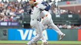 The Houston Astros' Alex Bregman reaches first base safely as the ball gets past Wilmer Flores of the San Francisco Giants in the fifth inning at Oracle Park on Tuesday, June 11, 2024, in...