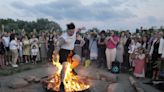 Ukrainians in Warsaw jump over a bonfire, float braids to celebrate solstice custom away from home - WTOP News