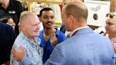 Former England star Paul Gascoigne kisses Prince William during visit to Bournemouth Pret A Manger