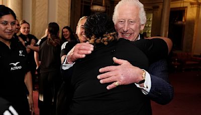 Charles beams as he is stormed with 'healing' hugs from rugby players