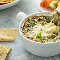 A dip made with spinach, artichoke hearts, cream cheese, sour cream, mayonnaise, and various seasonings, often served with bread or chips. Popular in the United States and often served as an appetizer.