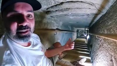 Traveller films journey through narrow tunnels in an Egyptian pyramid