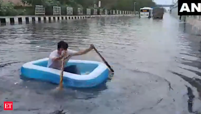 Delhi rain: Traffic crawls, people wade through waterlogged areas; BJP councillor rows in protest