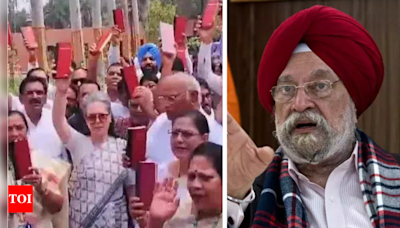 'As Charlie Chaplin said ...': Union minister Hardeep Puri's dig at opposition over holding up copies of Constitution | India News - Times of India