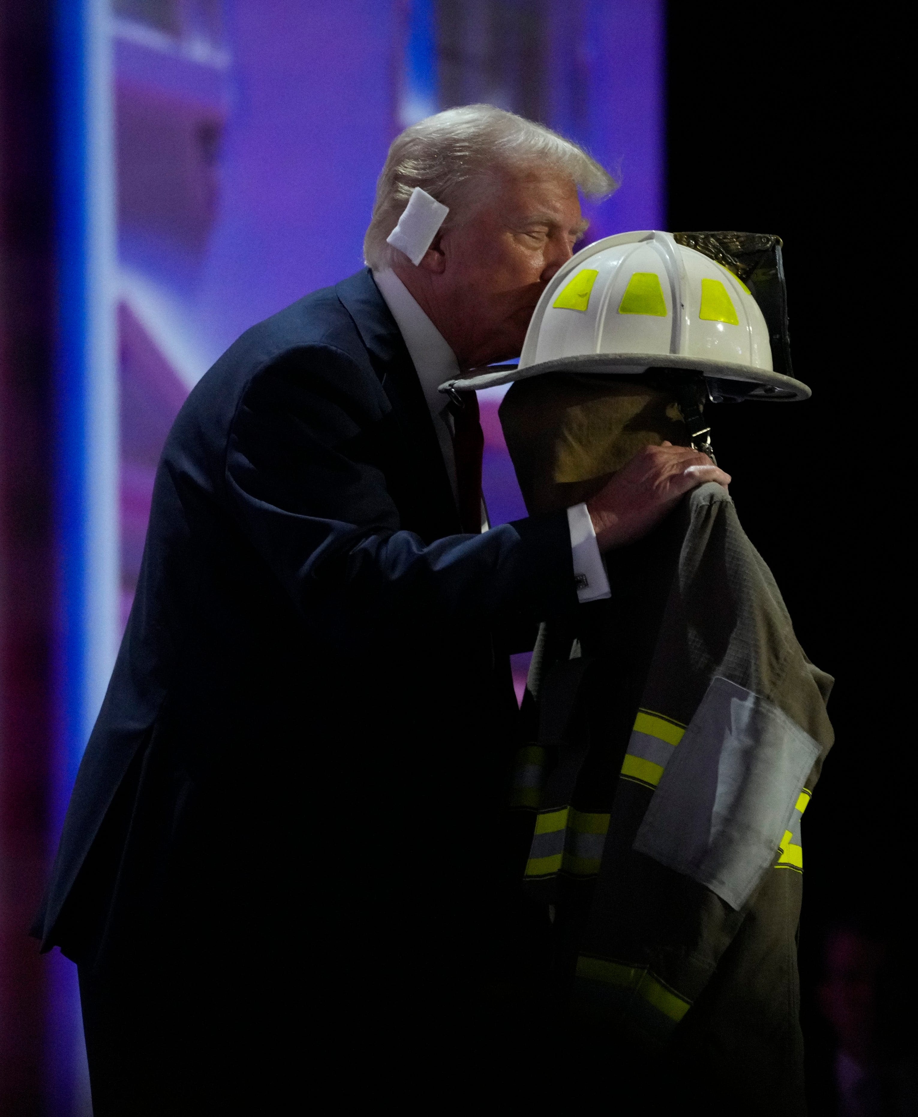 Trump kisses fire suit of fallen rally goer Corey Comperatore on RNC stage