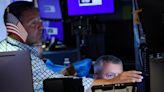 Wall St ends volatile session lower in aftermath of global tech outage