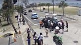 VIDEO: Good Samaritans rush to free motorcyclist trapped underneath car at popular beach