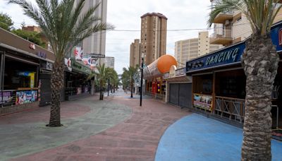 Inside abandoned Benidorm street with desolate nightclub & rotting golf course