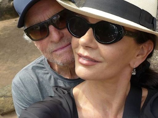 Catherine Zeta-Jones steals a kiss with 'lucky' husband Michael Douglas on set