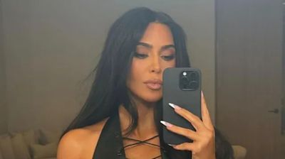 Kim Kardashian Shares Flirty Photos in Plunging Lace Up Top