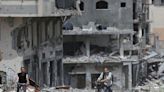 Battles rage across Gaza Strip, Israel shows images of gunmen at UN site