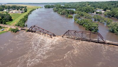 Midwestern flooding collapses a bridge, forces evacuations and kills at least 2