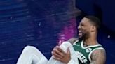 Milwaukee's Damian Lillard clutches his knee after a fall in the first quarter of the Bucks' NBA Eastern Conference first-round playoff game against the Indiana Pacers