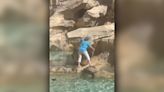 Watch: Tourist caught climbing across Rome's historic Trevi Fountain to fill up water bottle