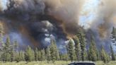 Gusty winds help spread fast growing central Oregon wildfire and prompt evacuations