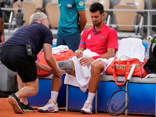 Novak Djokovic's knee injury bothers him at the Paris Olympics but he beats Stefanos Tsitsipas