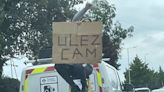 Ulez protester scales ladder to block camera on van